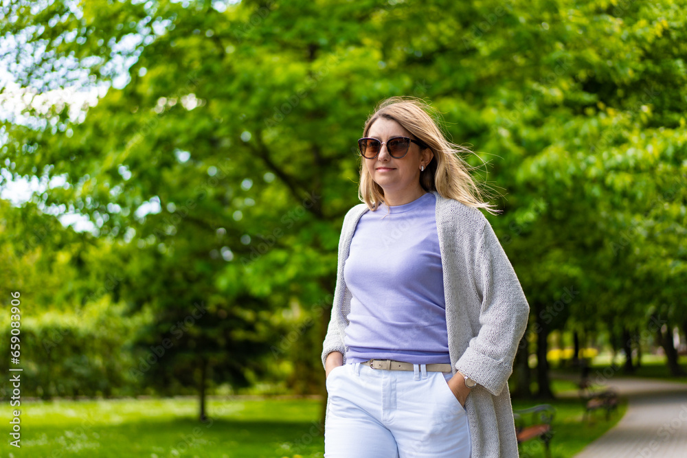 Healthy lifestyle - woman walking in city park
Healthy lifestyle - woman walking in city park