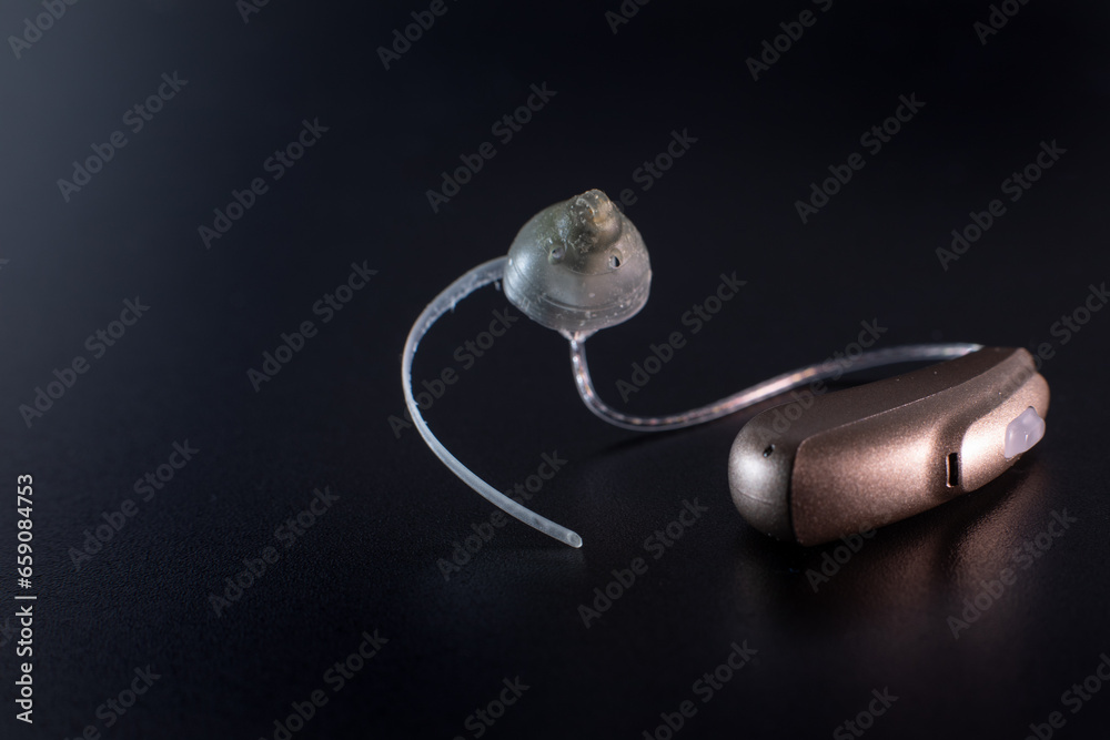 hearing aid lie on a black background hearing aid lie on a black background