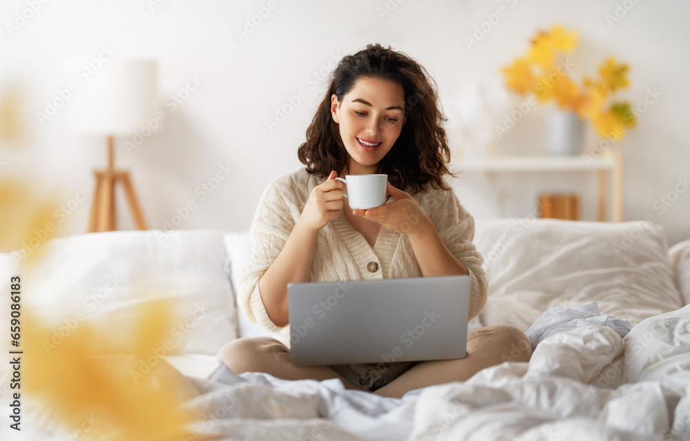 woman wearing warm clothes is using laptop woman wearing warm clothes is using laptop