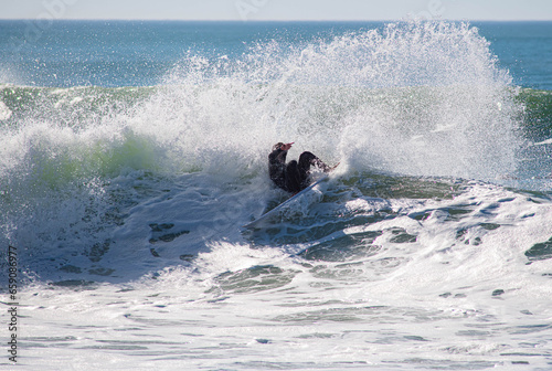 Surfer in a barrel falling under the force of the waves photo