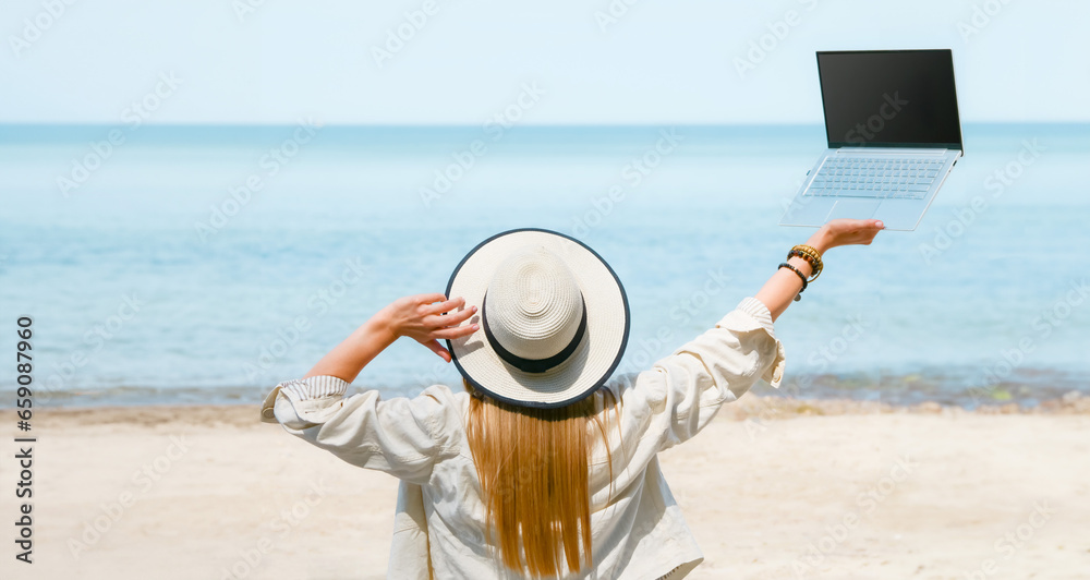 young woman uses laptop computer on the beach. distance work, freelancer and blogger concept. WiFi unlimited
