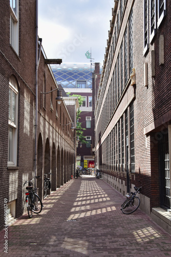 street in the old town of amsterdam  bicycles in alley  vertical photo 
