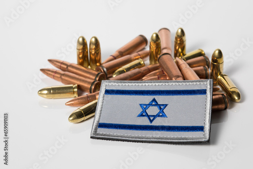 Israel flag with weapon ammunition. War between Israel and Lebanon. 7.62x39 rifle bullets ammunition. IDF military. Conflict situation and fighting. Crisis. photo