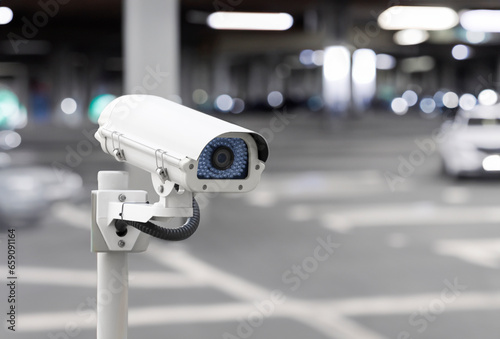 Modern public CCTV camera at gantry parking area at night with blur background