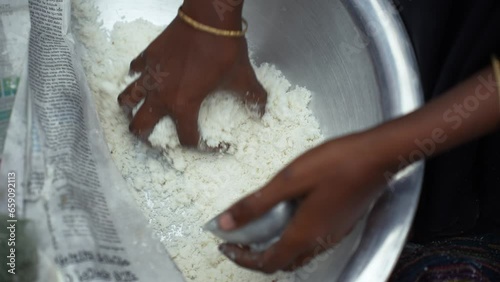 Making traditional rice cake called Bhapa Pitha, a soft and syrupy rice cake steamed to perfection, featuring coconut and jaggery for a deliciously sweet taste photo