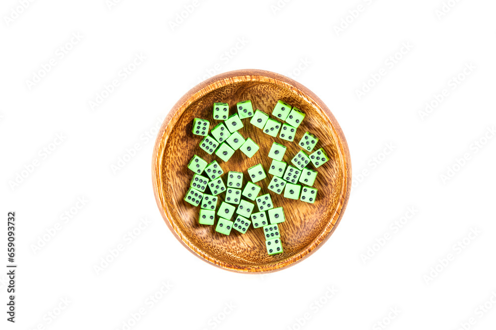Handful of tiny green neon dice in a wooden cup isolated over white