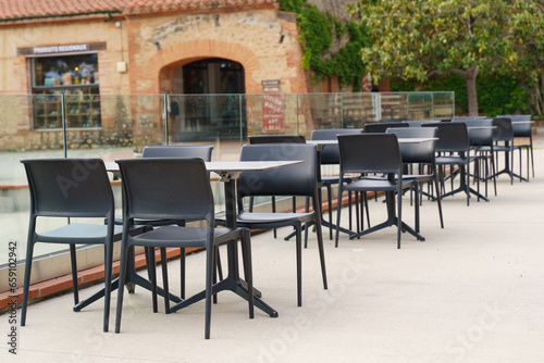 Plastic tables and chairs in a cafe empty in the morning.