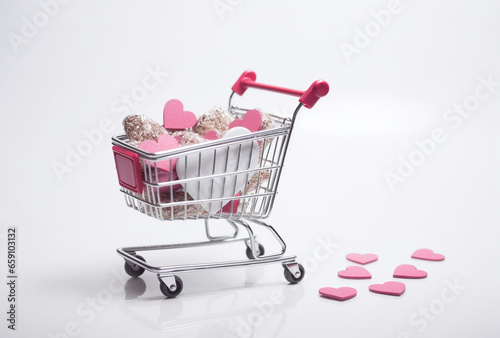 Many of hearts in a shopping trolley on a white background