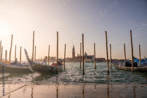 Venice lagoon at sunrise, San Giorgio Maggiore church and gondolas. Italy, Europe
