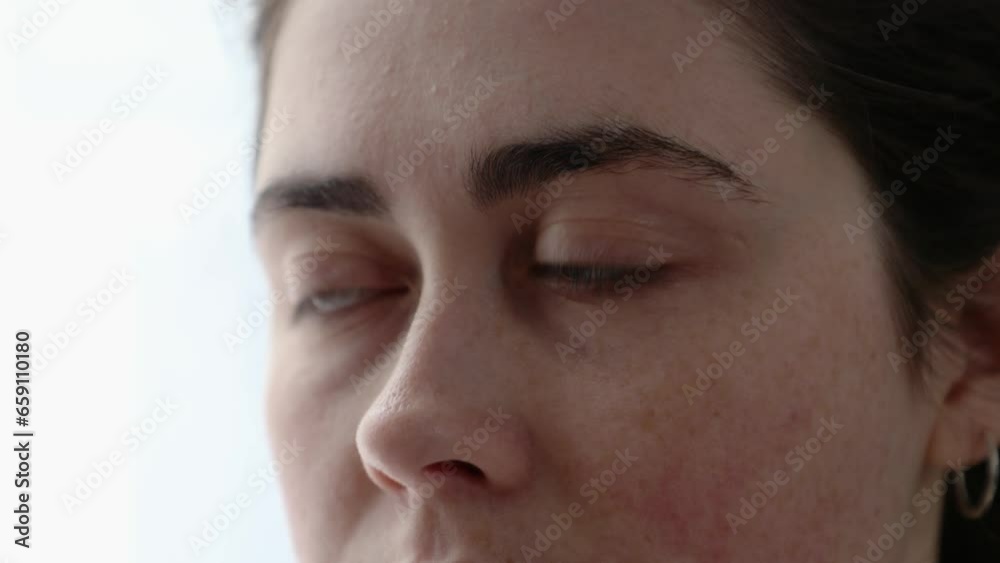Close-up of a woman's face with wet sad eyes. Sadness, depression and eye diseases. Itch and allergy Close-up of a woman's face with wet sad eyes. Sadness, depression and eye diseases. Itch and allergy