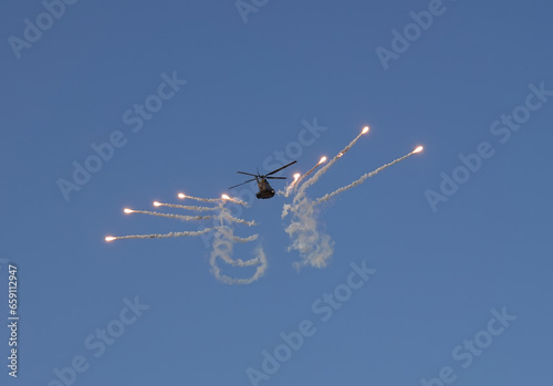military helicopter firing decoy flares  
