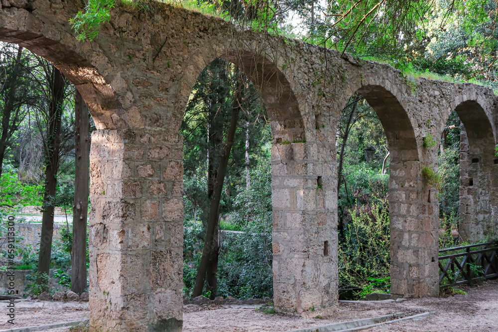 Aqueduct, a watercourse arch over the Rodini Park lake and walking path located in central Rhodes