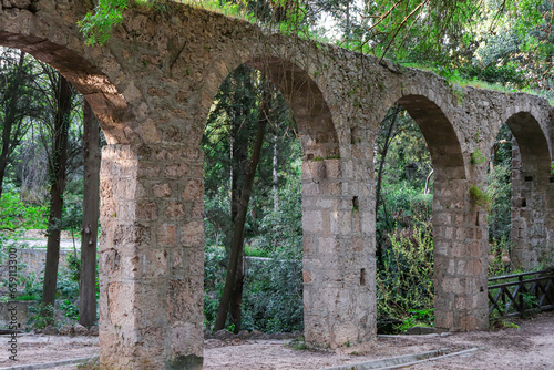 Aqueduct, a watercourse arch over the Rodini Park lake and walking path located in central Rhodes