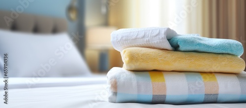 A pair of towels arranged on a bed representing hospitality