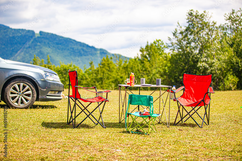 Family camping in nature, camping table and chairs Family camping in nature, camping table and chairs