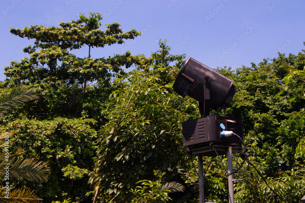 large spotlights located between shady trees large spotlights located between shady trees
