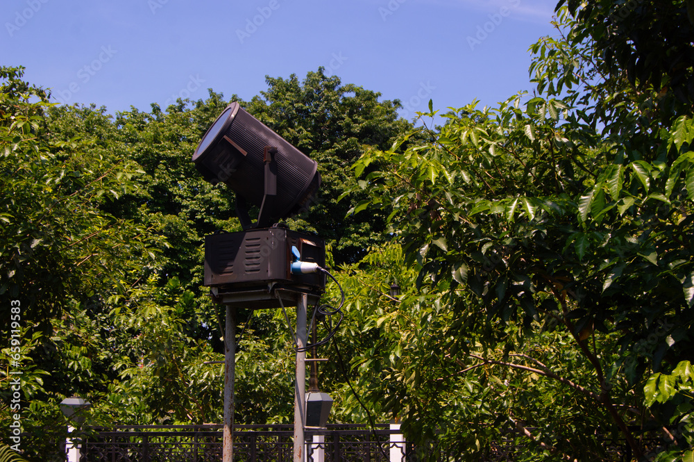 large spotlights located between shady trees large spotlights located between shady trees
