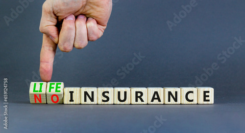 Life or no insurance symbol. Concept words Life insurance No insurance on wooden blocks. Beautiful grey table grey background. Businessman hand. Business Life or no insurance concept. Copy space.