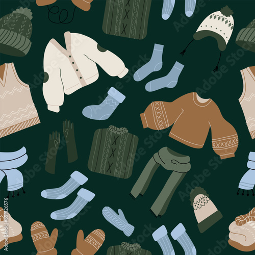 Seamless pattern with winter autumn cozy clothes and outerwear isolated on background - woolen jumper, cardigan, socks, scarf, hat, mittens. Bundle of seasonal clothing. Colorful vector illustration.