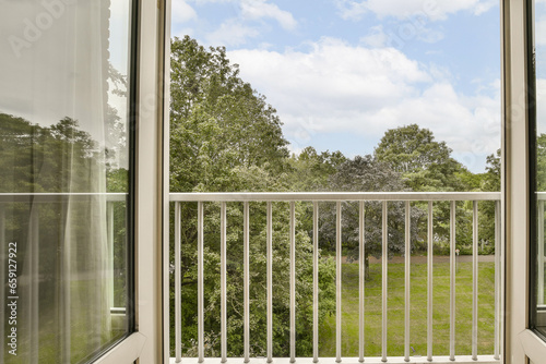 an outside area with trees and grass in the background  taken from inside a window looking out onto a grassy field