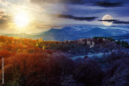 autumn landscape with sun and moon at twilight. forest in the mountains covered with red and yellow foliage. day and night time change concept. mysterious countryside scenery in morning light © Pellinni