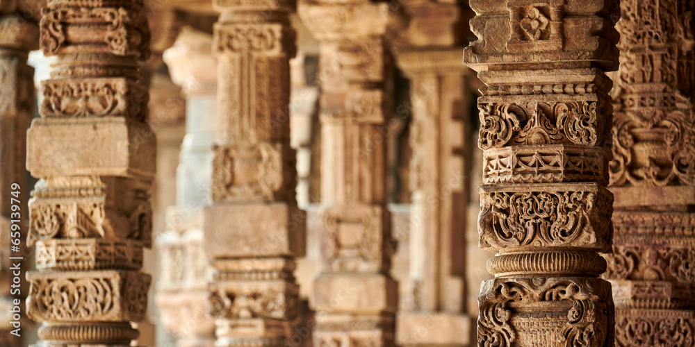 Stone columns with decorative bas relief of Qutb complex in South Delhi, India, close up pillars - obrazy, fototapety, plakaty 