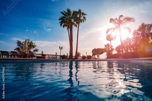 Outdoor swimming pool water over warm sunset light