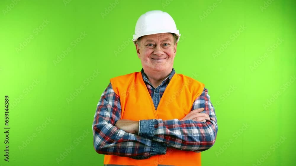 Confident senior friendly builder in hardhat smiling and crossing his arms. Confident senior friendly builder in hardhat smiling and crossing his arms.