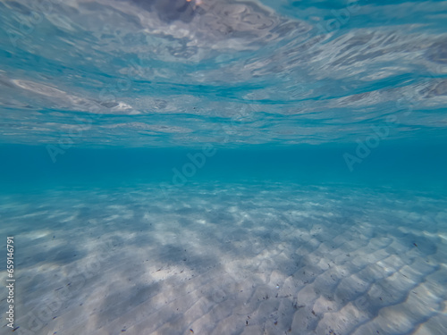 Underwater photo on the beach in Athens. Clean water and sandy bottom.