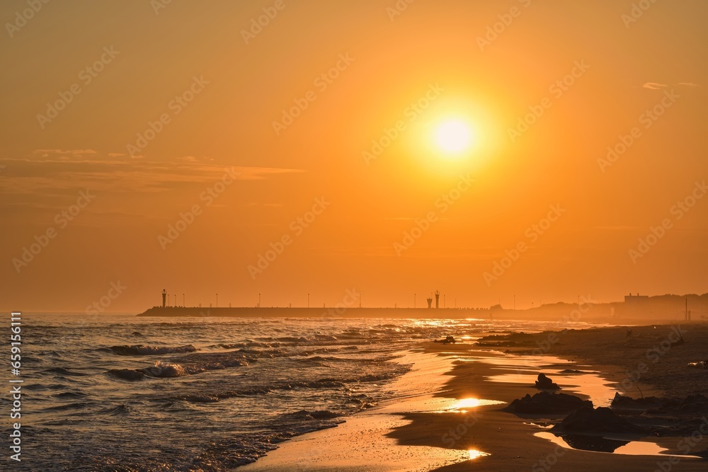 Colorful morning landscape on the Polish Baltic Sea. Sunrise on the beach in Leba, Poland.