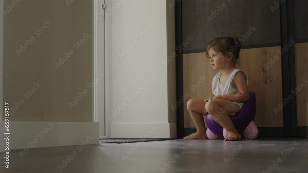 Cute little toddler baby girl child sitting on potty. Toilet training concept. Baby learning, development steps. Cute little toddler baby girl child sitting on potty. Toilet training concept. Baby learning, development steps.