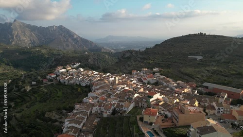 Aerial view Mountain landscape in old town Tarbena, Flight towards Valley with Altea in background, Alicante, Spain