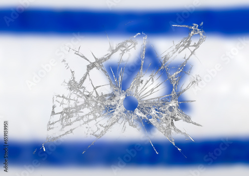 Bullet hole in dirty glass with Israel background