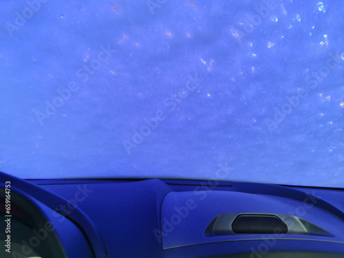 Automatic Car Wash Process. Spray foam bubble shampoo on the car surface. Car wash view from the salon