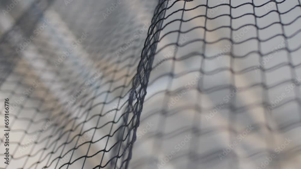 Net for playing volleyball in modern sports gym. Equipment for physical education classes in fitness gym low angle shot Net for playing volleyball in modern sports gym. Equipment for physical education classes in fitness gym low angle shot
