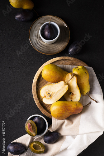 juicy pear with plum on the kitchen table