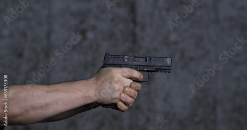 Gun at shooting range in super slow-motion 800 fps. Close-up of Stoeger STR9 firing photo