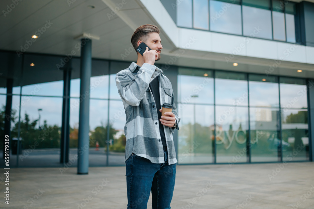 City charm A good looking guy connects with his phone in the urban environment. Fashionable Connection Lovely Portrait of a Young Adult on Cellphone City charm A good looking guy connects with his phone in the urban environment. Fashionable Connection Lovely Portrait of a Young Adult on Cellphone