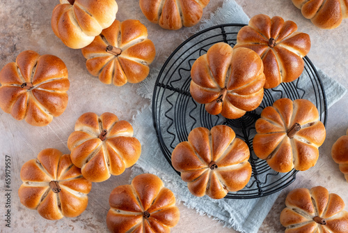 Pumpkin buns bread with spices on brown background. Autumn concept.