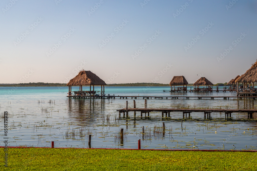 Laguna de Bacalar is also known as the Lagoon of Seven Colors, in Bacalar, Mexico. The crystal clear waters and white sandy bottom of the lake cause the water color to morph into varying shades of tur Laguna de Bacalar is also known as the Lagoon of Seven Colors, in Bacalar, Mexico. The crystal clear waters and white sandy bottom of the lake cause the water color to morph into varying shades of tur