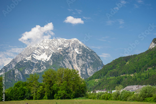 Obraz na płótnie Summer austrian landscape with green meadows and Grimming mountain (2.351 m), an isolated peak in the Dachstein Mountains, in Styria region, Austria w salonie