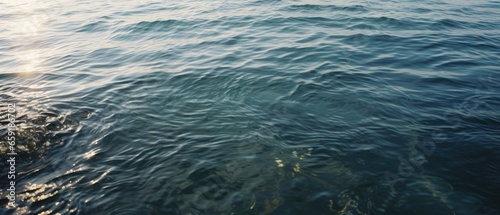 Detailed capture of the quiet ocean, reef bathed in morning light, and dark grey olive blue tints