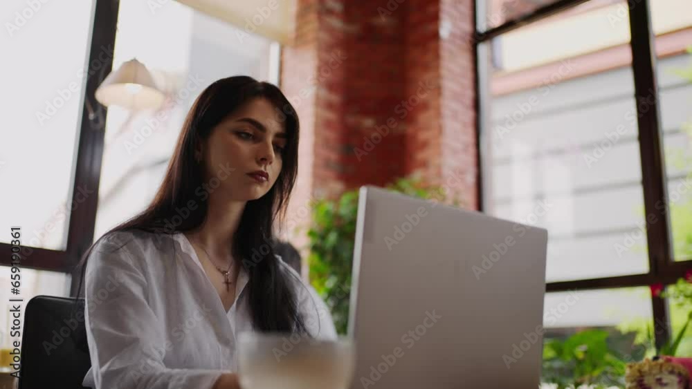 Pretty Brunette Woman Working With Notebook In Cafe, Portrait Of Female Freelancer Working Remotely Pretty Brunette Woman Working With Notebook In Cafe, Portrait Of Female Freelancer Working Remotely