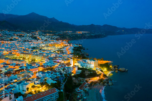 Scenic view from drone of spanish town of Nerja on southern Mediterranean coast at night, Malaga, Spain