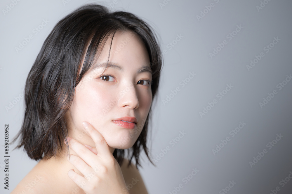 Fototapeta premium 美容で使いやすい若い女性のスキンケアのビューティーイメージ 顔のクローズアップ アンニュイな表情