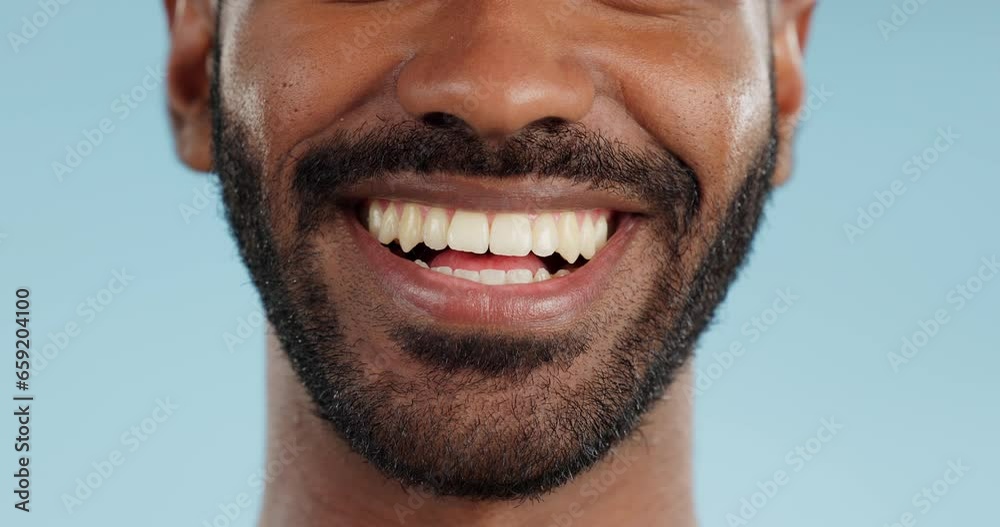 Smile, closeup and black man with teeth in studio, blue background and mockup space with happiness or advertising. Dental, lips and marketing for skincare, wellness or healthy dermatology care Smile, closeup and black man with teeth in studio, blue background and mockup space with happiness or advertising. Dental, lips and marketing for skincare, wellness or healthy dermatology care