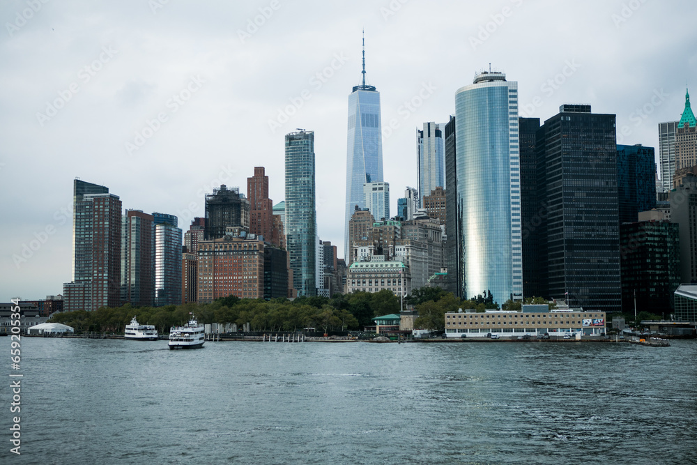 Obraz premium New York, New York state USA - August, 30, 2023 - Staten island ferry on the hudson river in lower manhattan in New York city on a sunny day, United States.