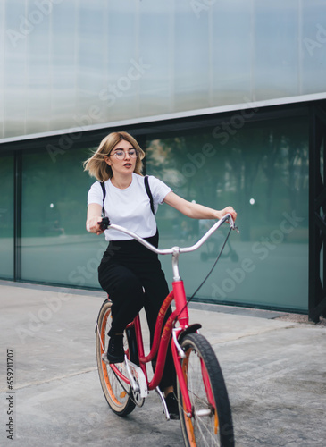 Student female cycling on street