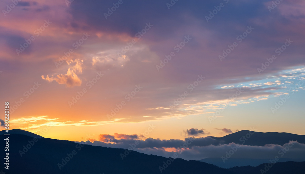 Autumn sunrise cloudy sky over mountains; Abstract colorful peaceful sky background