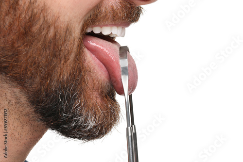 Man brushing his tongue with cleaner on white background, closeup